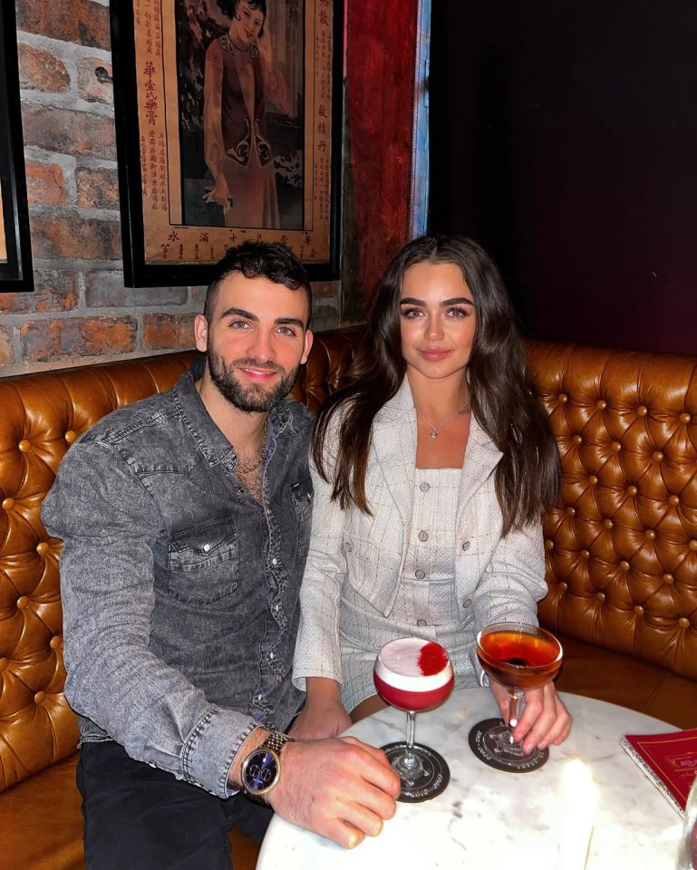 Couple sitting at a bar with cocktails.