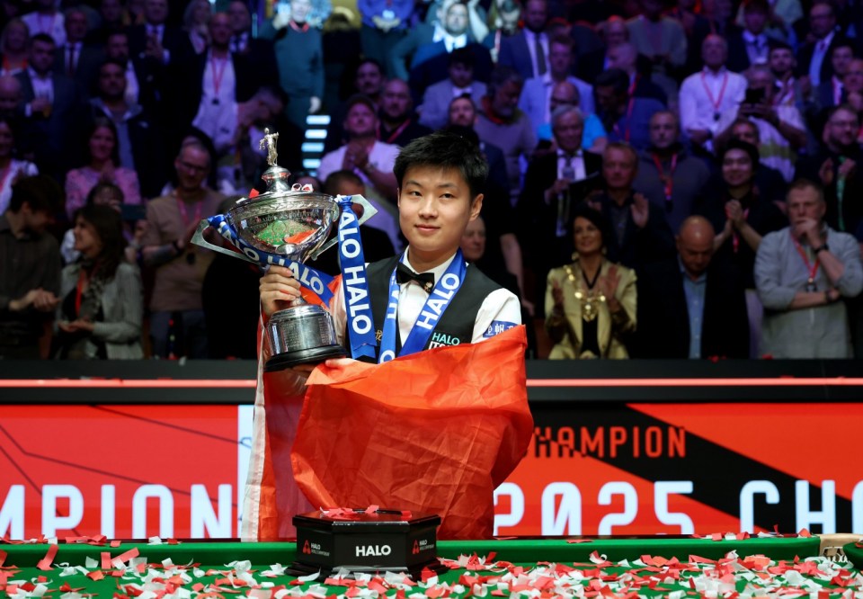 Mandatory Credit: Photo by Xinhua/REX/Shutterstock (15285634f) Zhao Xintong celebrates with the trophy during the awarding ceremony after the final between Zhao Xintong of China and Mark Williams of Wales at World Snooker Championship 2025 in Sheffield, Britain, May 5, 2025. Britain Sheffield Snooker World Championship Final - 06 May 2025