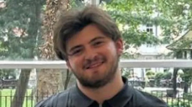 Portrait of a young man smiling.