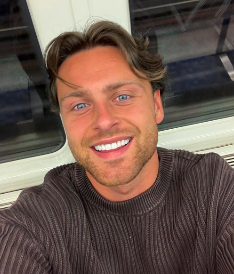 Man smiling on public transportation.