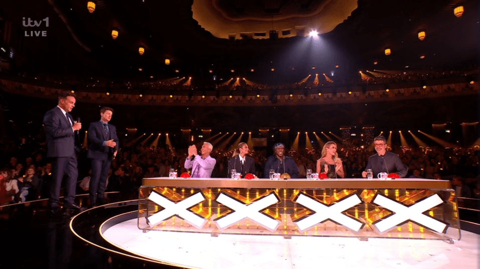 Screenshot of the X Factor judging panel and hosts.