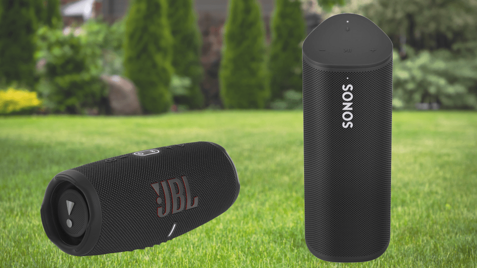 JBL and Sonos portable speakers on a lawn.