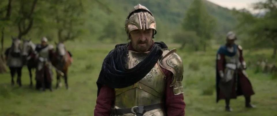 Actor in medieval armor on a field.
