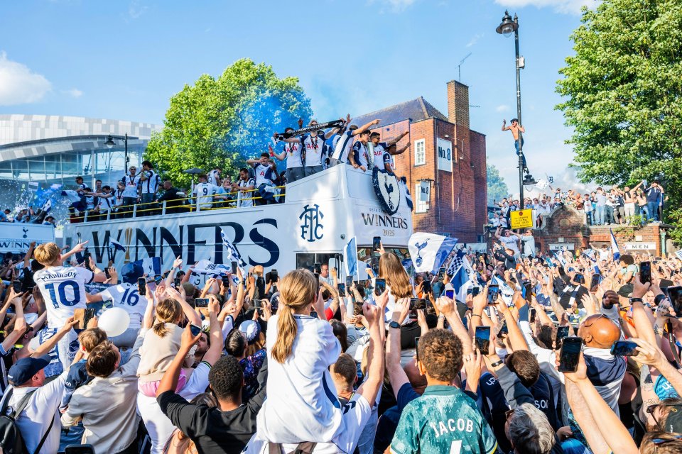 Tottenham Hotspur players celebrating their Europa League victory in a parade.