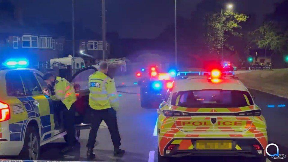 Police officers at a night-time accident scene.