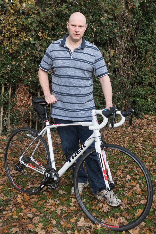 Man standing with his damaged bicycle after a hit and run accident.