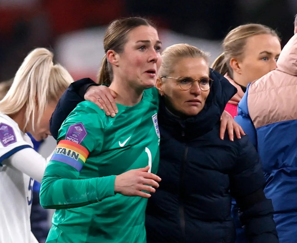 England manager Sarina Wiegman consoles Mary Earps after a soccer match.