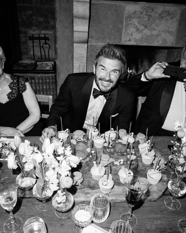 Black and white photo of David Beckham at a birthday dinner.