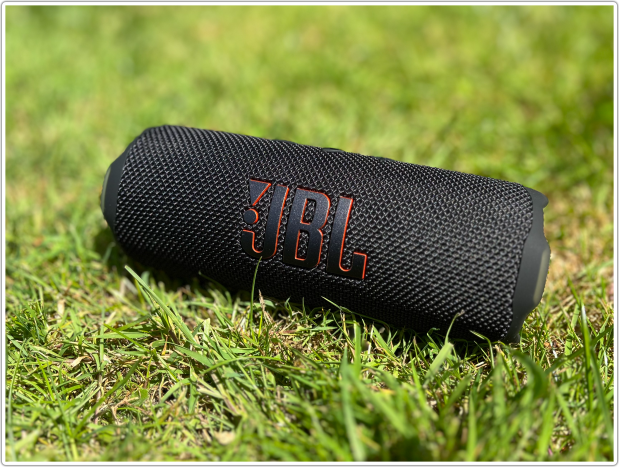 JBL portable Bluetooth speaker on the grass.