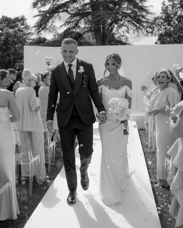 Dani Dyer and Jarrod Bowen walking down the aisle after their wedding ceremony.