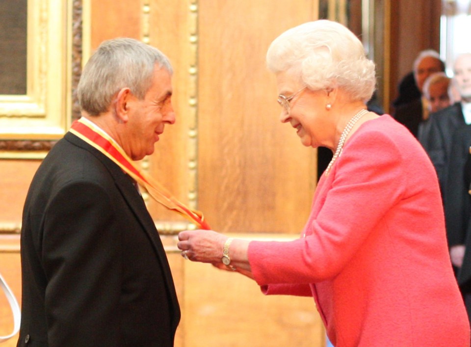 Queen Elizabeth II knighting Sir Ian McGeechan.