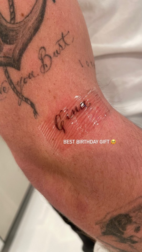 Close-up photo of a new tattoo that says "Gina."