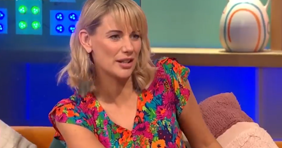 Woman in floral top on a talk show.