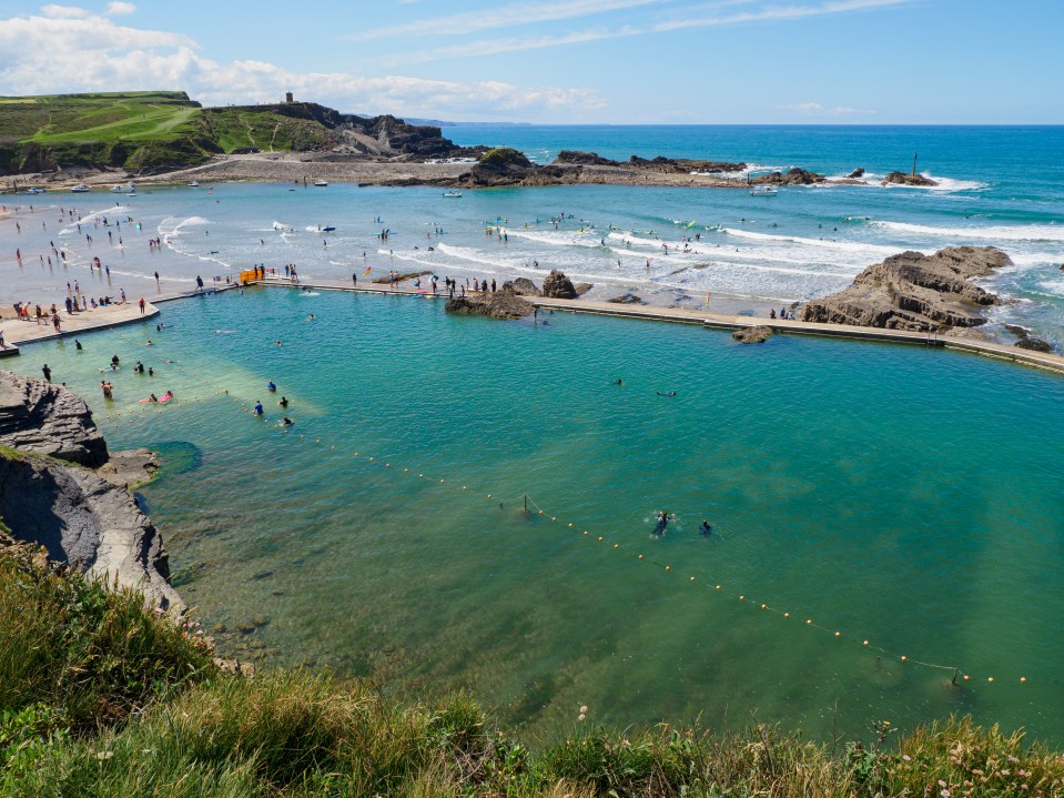 Aerial view of Bude sea pool with people swimming.