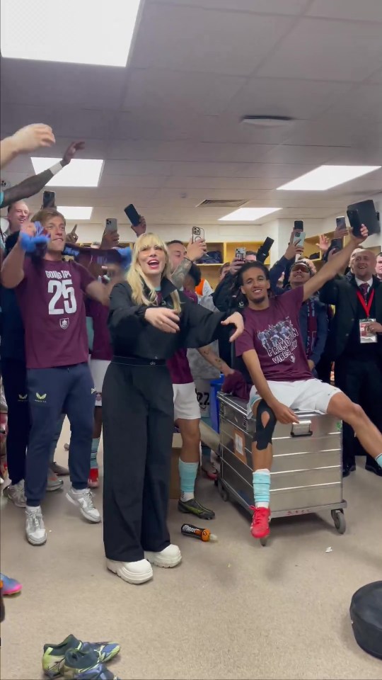 Burnley football players celebrating promotion with a singer.