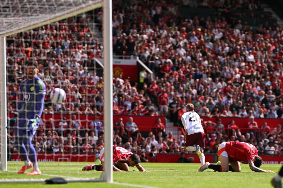 Soccer player celebrating a goal in front of a crowd.
