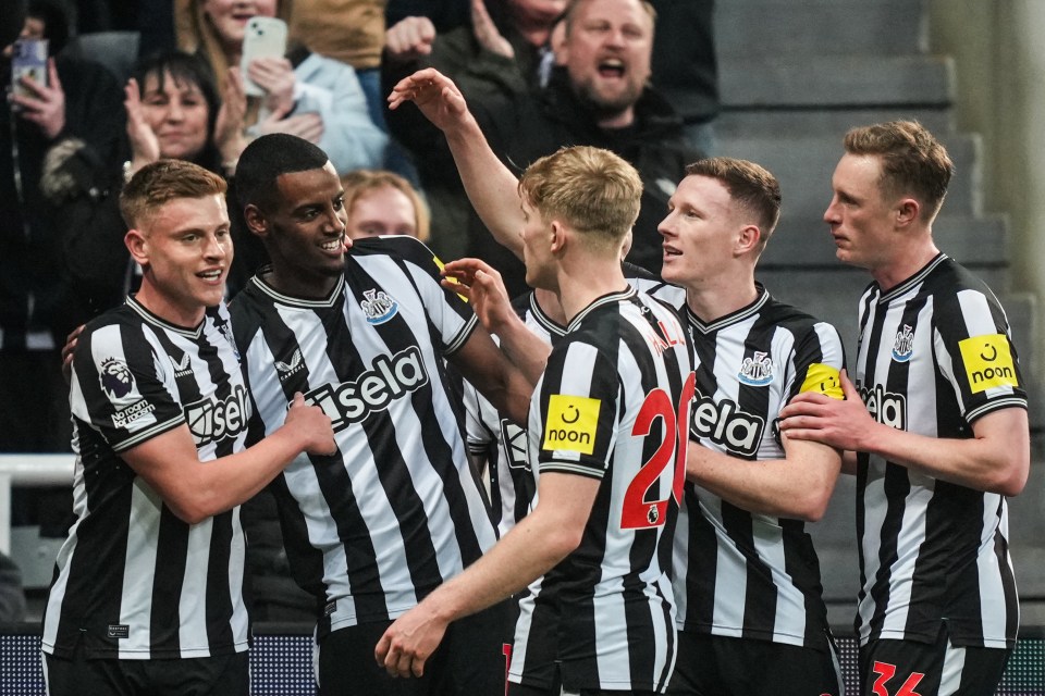 Newcastle United players celebrating a goal.