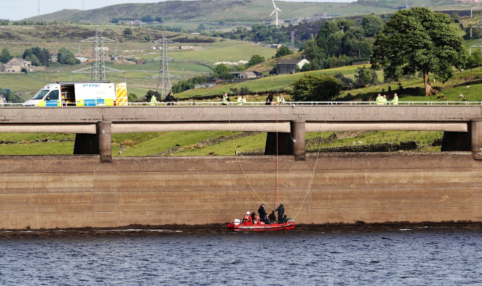 Underwater search team in a boat at a reservoir.