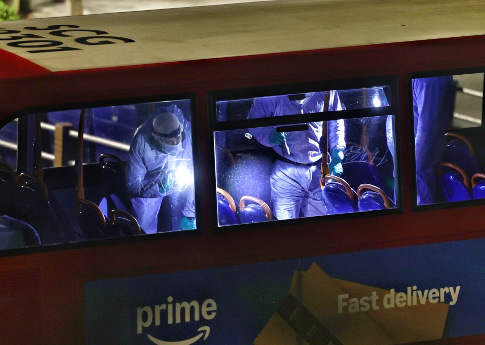 Forensic officers investigating a stabbing on a bus.