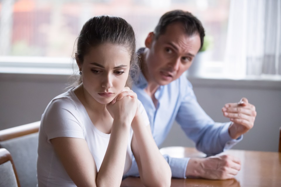 Upset woman listening to angry man.