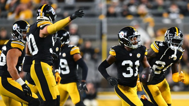 Pittsburgh Steelers player #31 running with the football after an interception.