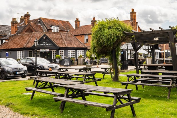 Outdoor beer garden with picnic tables at The Kings Head Pub.