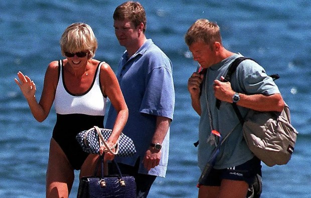 Princess Diana and three men walking on a dock in Saint-Tropez.