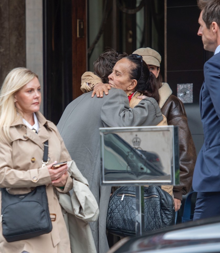 Cruz Beckham hugging his girlfriend and mother.