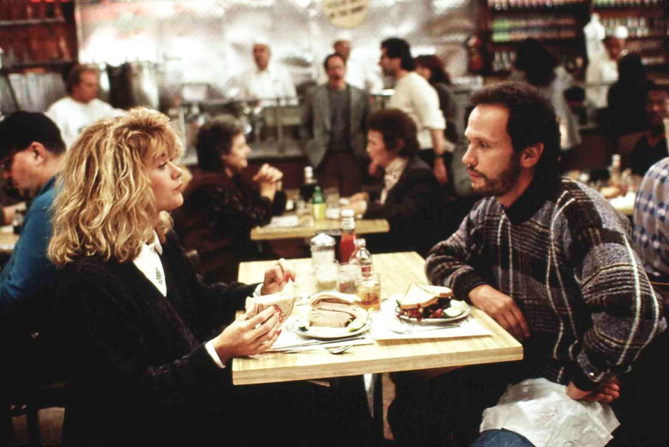 Meg Ryan and Billy Crystal eating sandwiches in When Harry Met Sally.