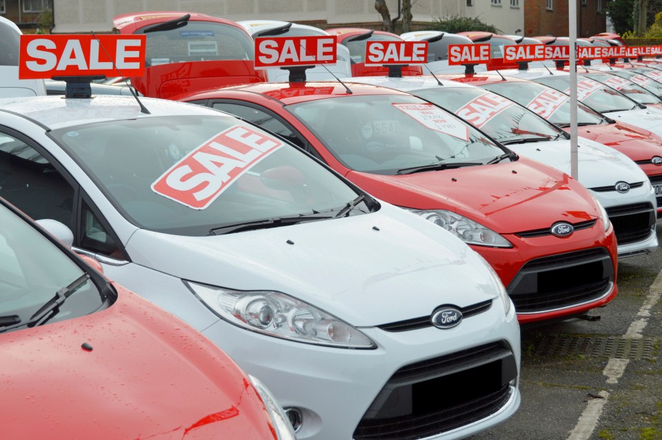 Row of used Ford cars for sale.
