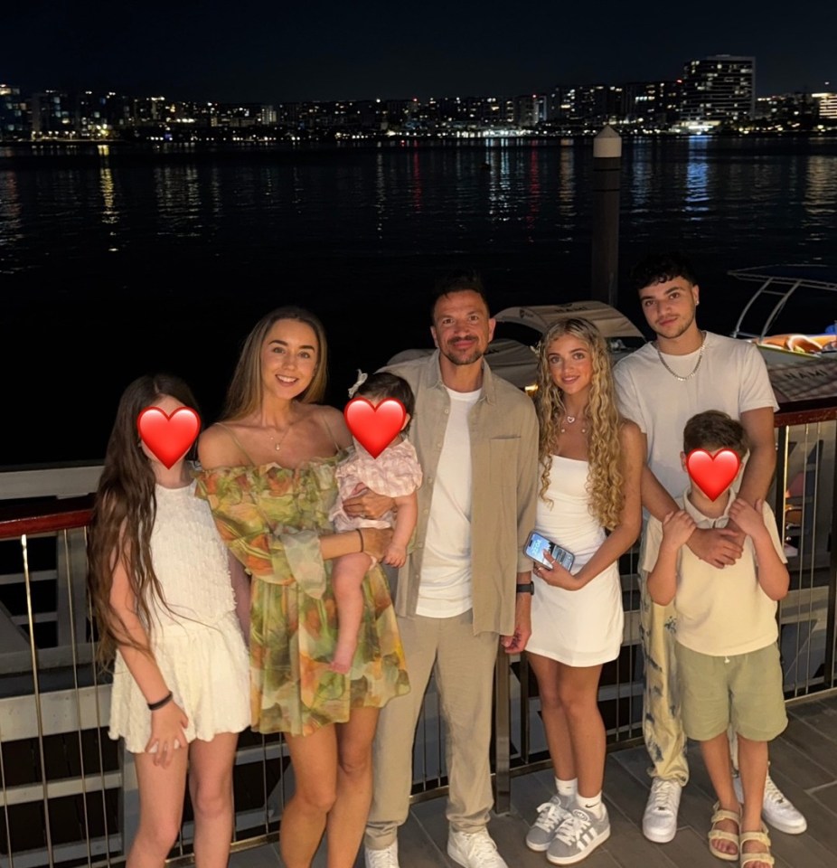 Family photo at night by the water.