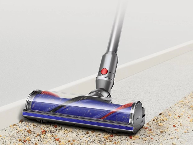 Dyson V12 Detect Slim Absolute vacuum cleaning a floor.