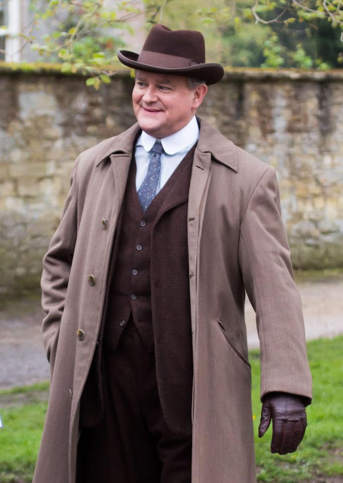 Hugh Bonneville in a brown suit and overcoat on the set of the Downton Abbey film.
