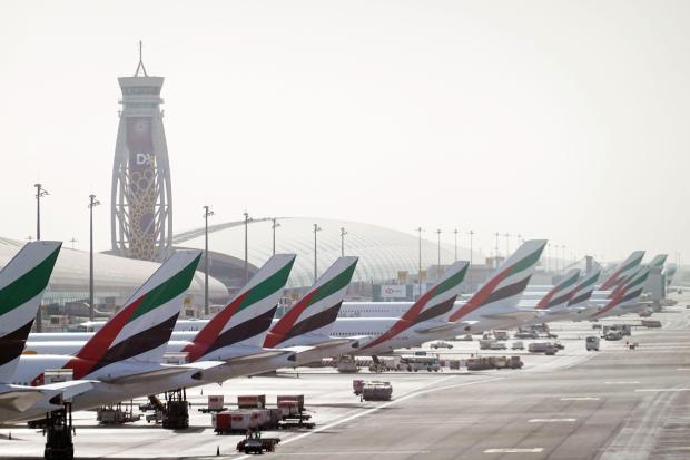 Emirates Airways planes parked at Dubai International Airport.