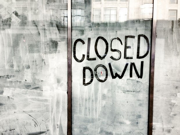 Closed down sign on a store window.