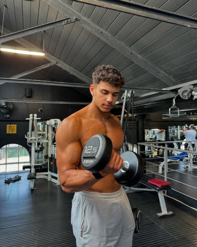 Man lifting weights in a gym.