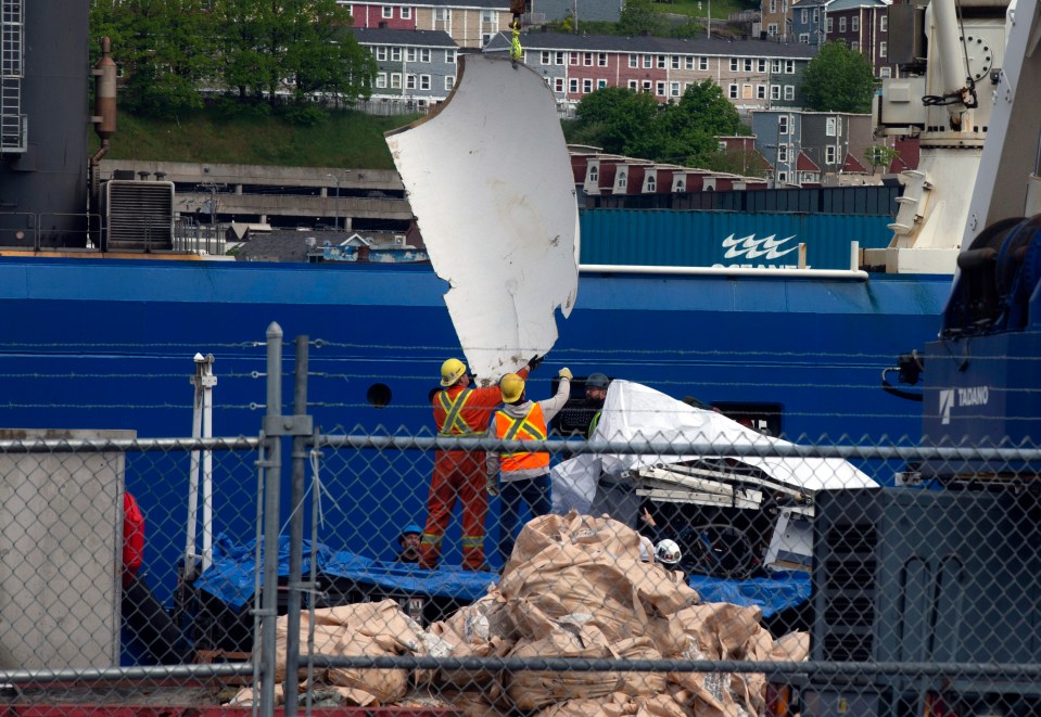 Debris from the Titan submersible being unloaded from a ship.