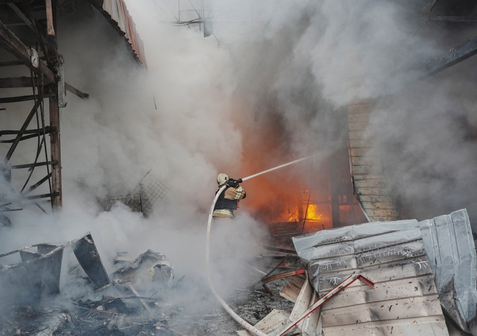 Firefighter battling a large fire at the Barabashovo market in Kharkiv, Ukraine.