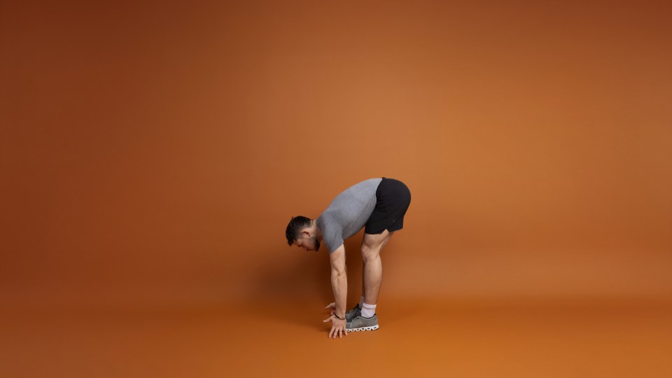Man performing a forward bend stretch.