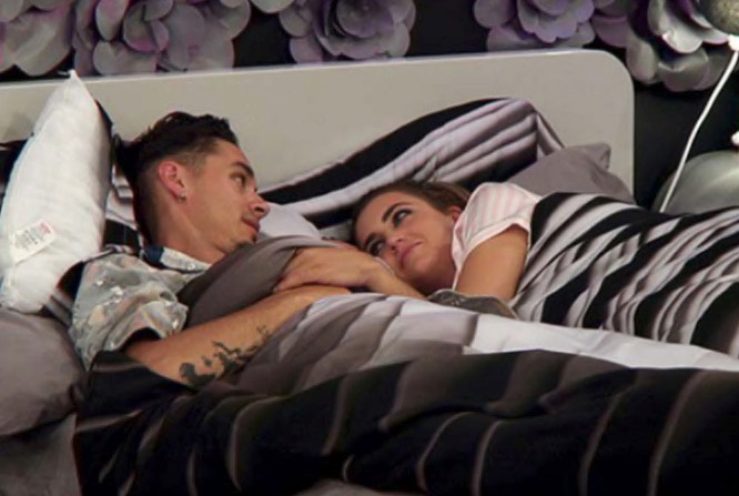 Couple cuddling in bed.