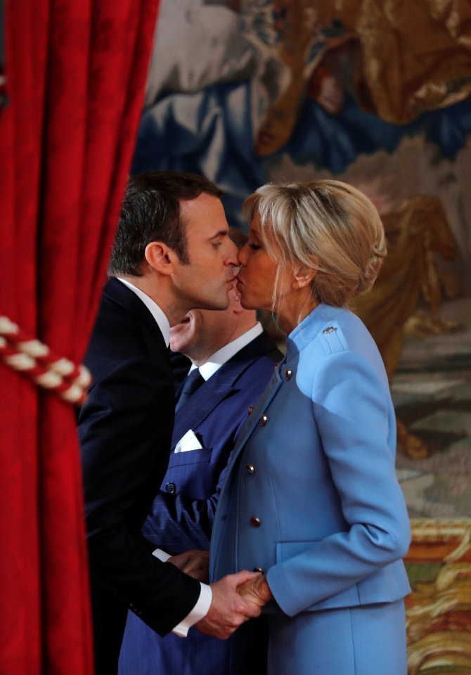 Emmanuel Macron kissing his wife.
