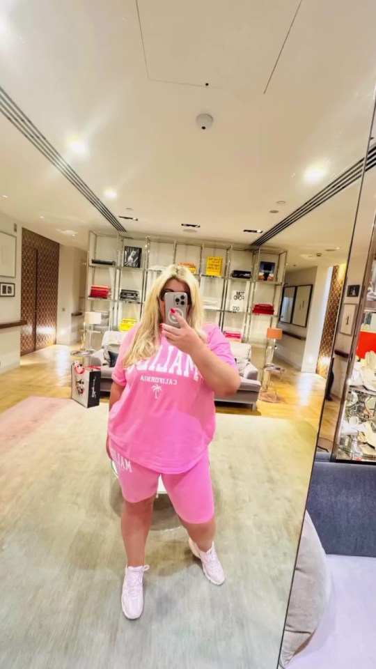 Gemma Collins in a pink tracksuit, taking a selfie.