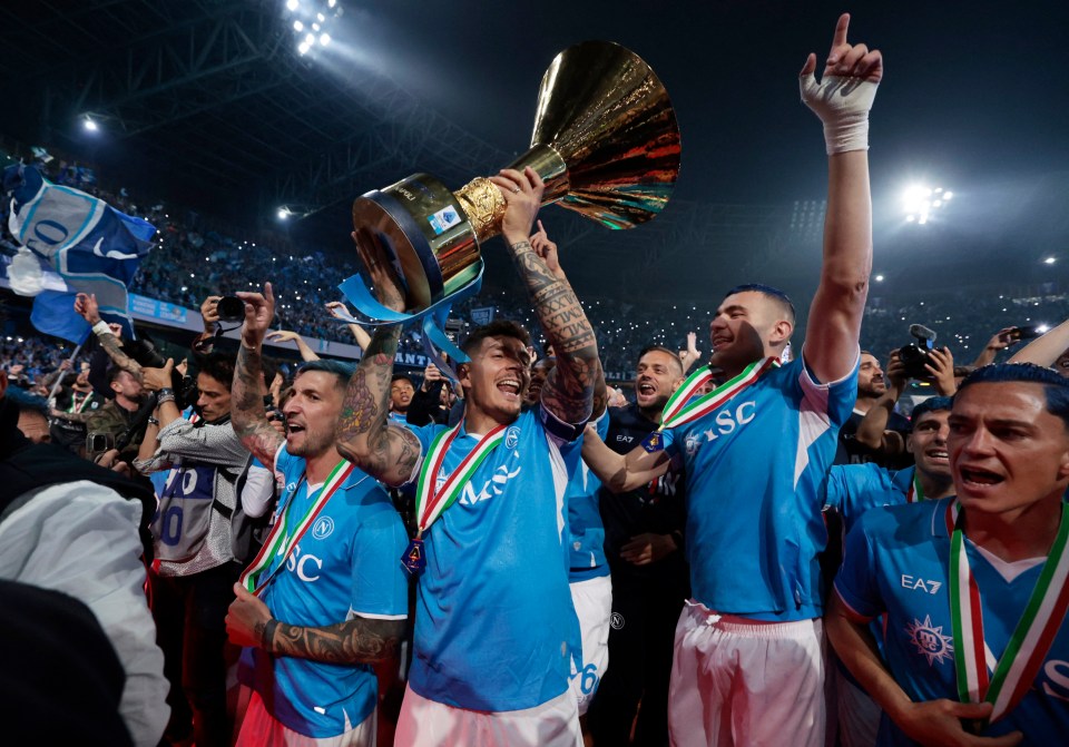 Napoli soccer players celebrating with the Serie A trophy.
