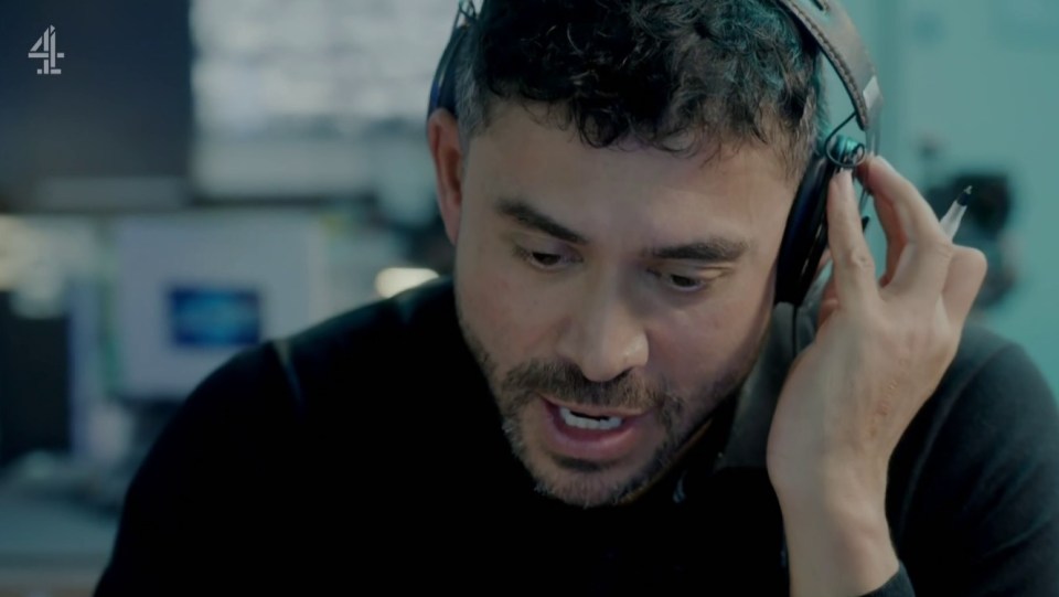 A man wearing headphones speaks intensely into a microphone.