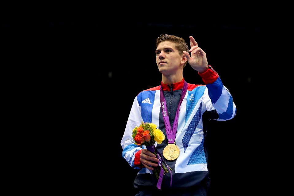 Luke Campbell, Olympic gold medalist, holding a bouquet and his medal.