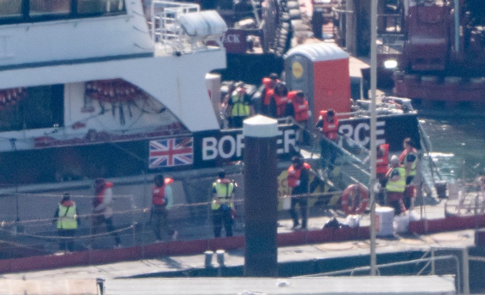 Migrants arriving in Dover, UK, via small boat.