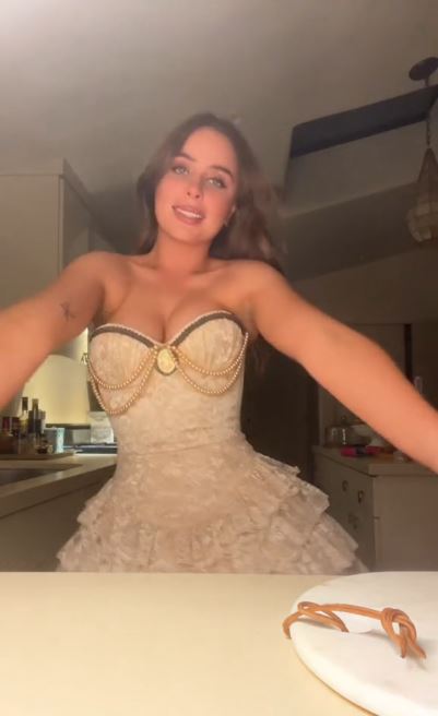 Stella Buckingham in a beige lace dress.