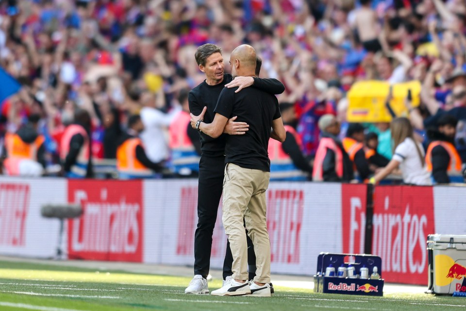 Oliver Glasner and Pep Guardiola embracing after a soccer game.