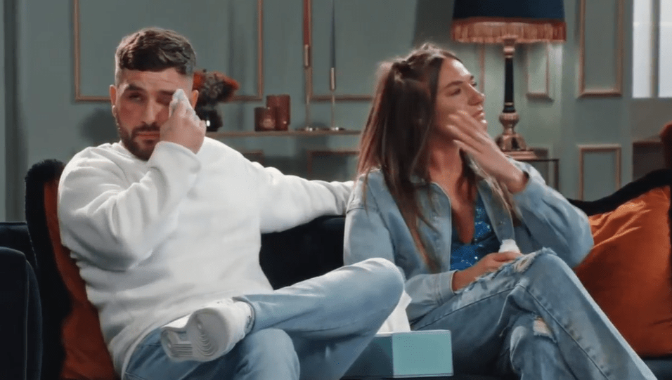 Kristina and Kieran crying on a couch.