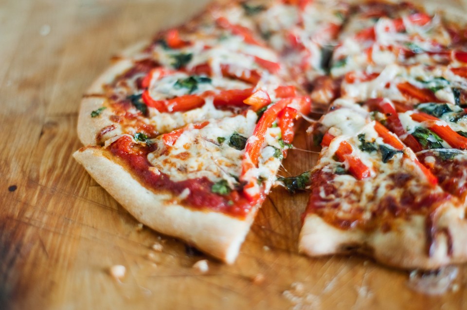 Homemade vegetarian pizza with marinara sauce.